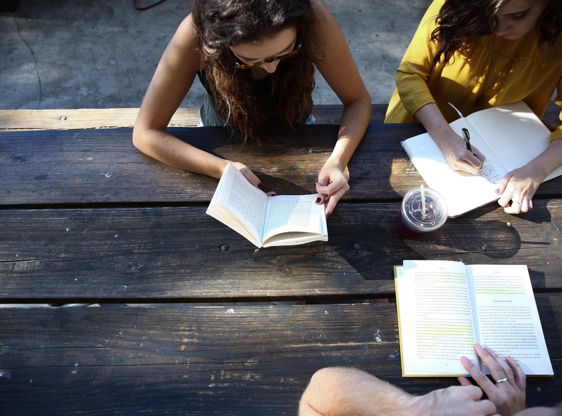 Three students studying at a picnic table